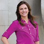 Woman in pink shirt, standing.