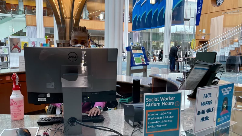 Social worker working in a walk-in atrium in a library