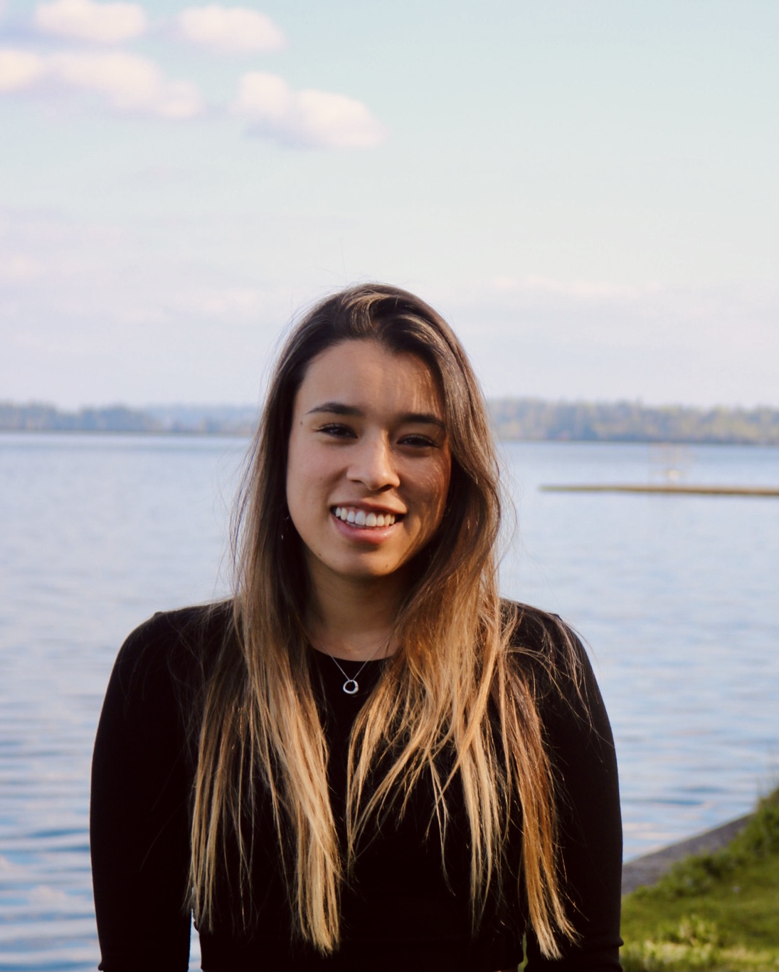 A headshot of a girl in front of the Ocean.