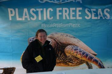 Student standing in front of a turtle poster