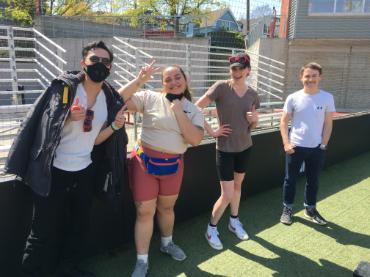 A group of Seattle University Film Studies students on the field during a kickball game.