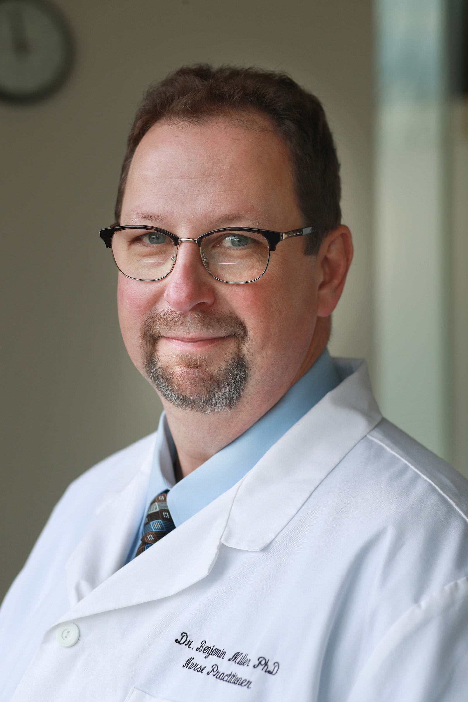 Nursing faculty member Benjamin Miller in a white lab coat