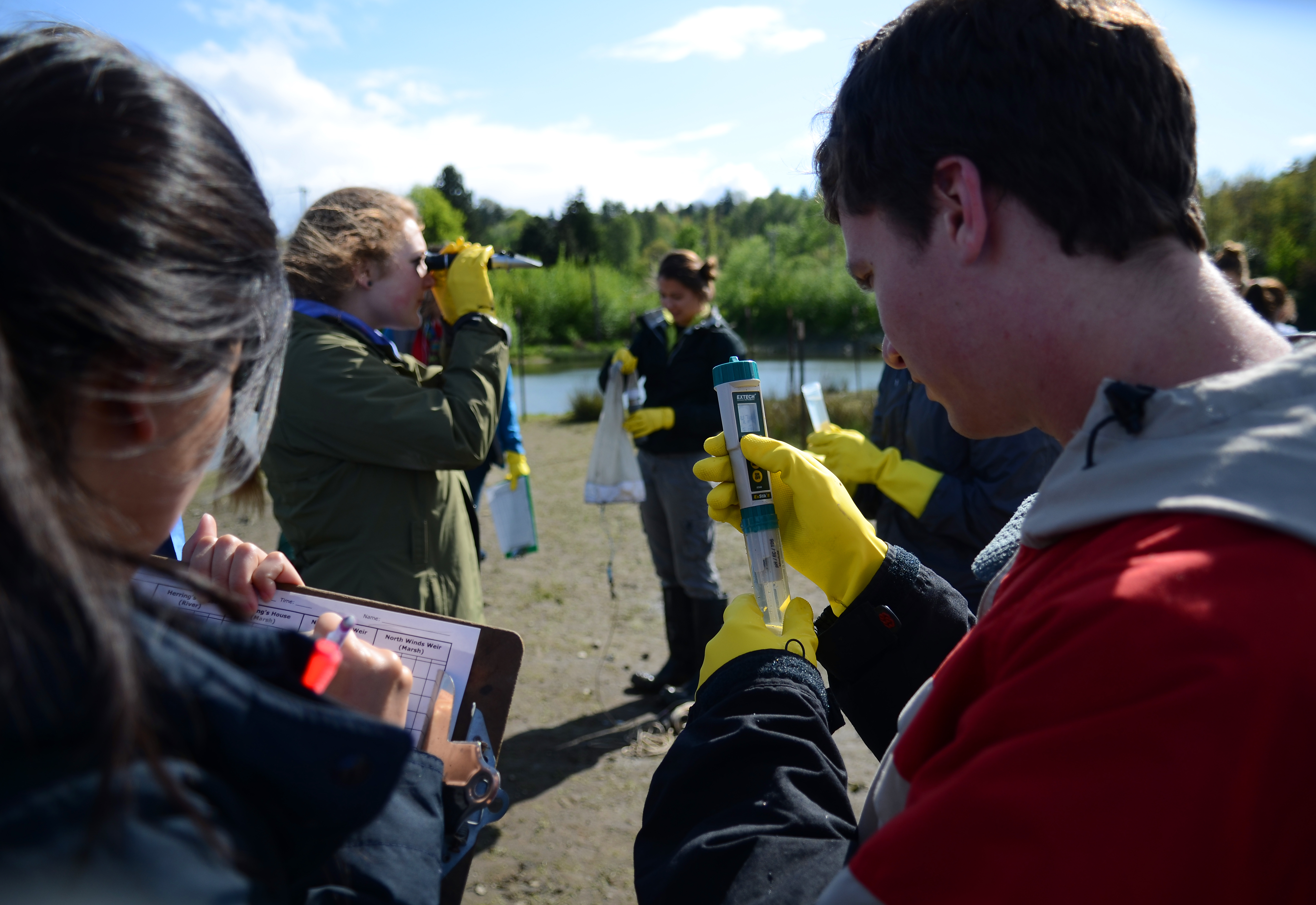 Students examine samples and record measurements.