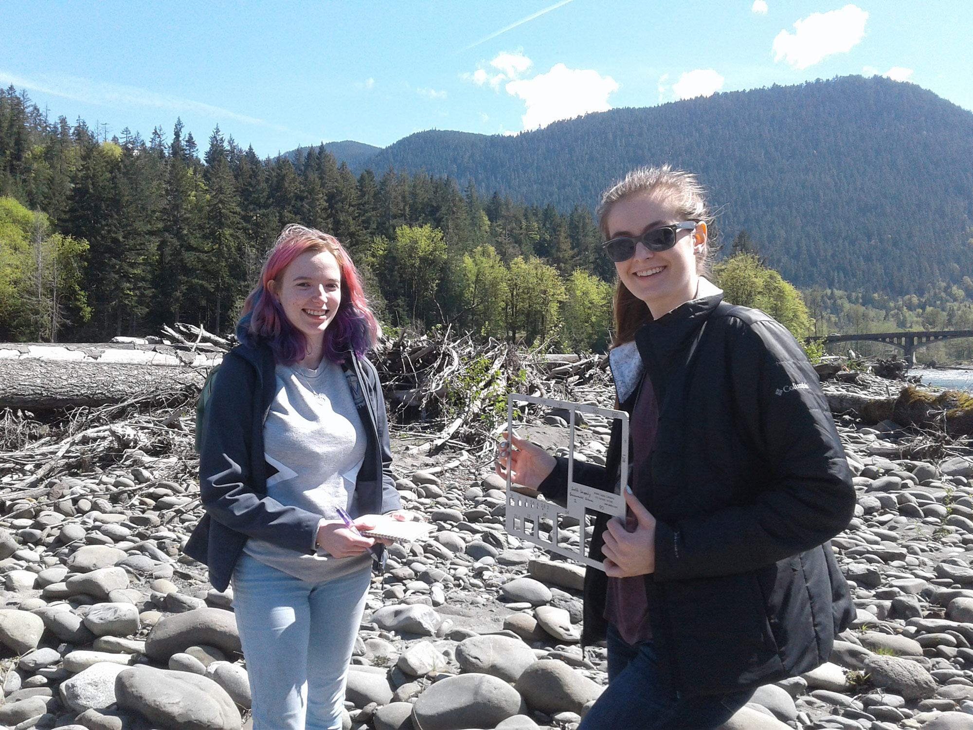 Students Working Together on a Riverbank