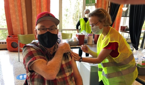 SU's president, Father Steve, gets vaccinated at the Swedish Clinic at SU