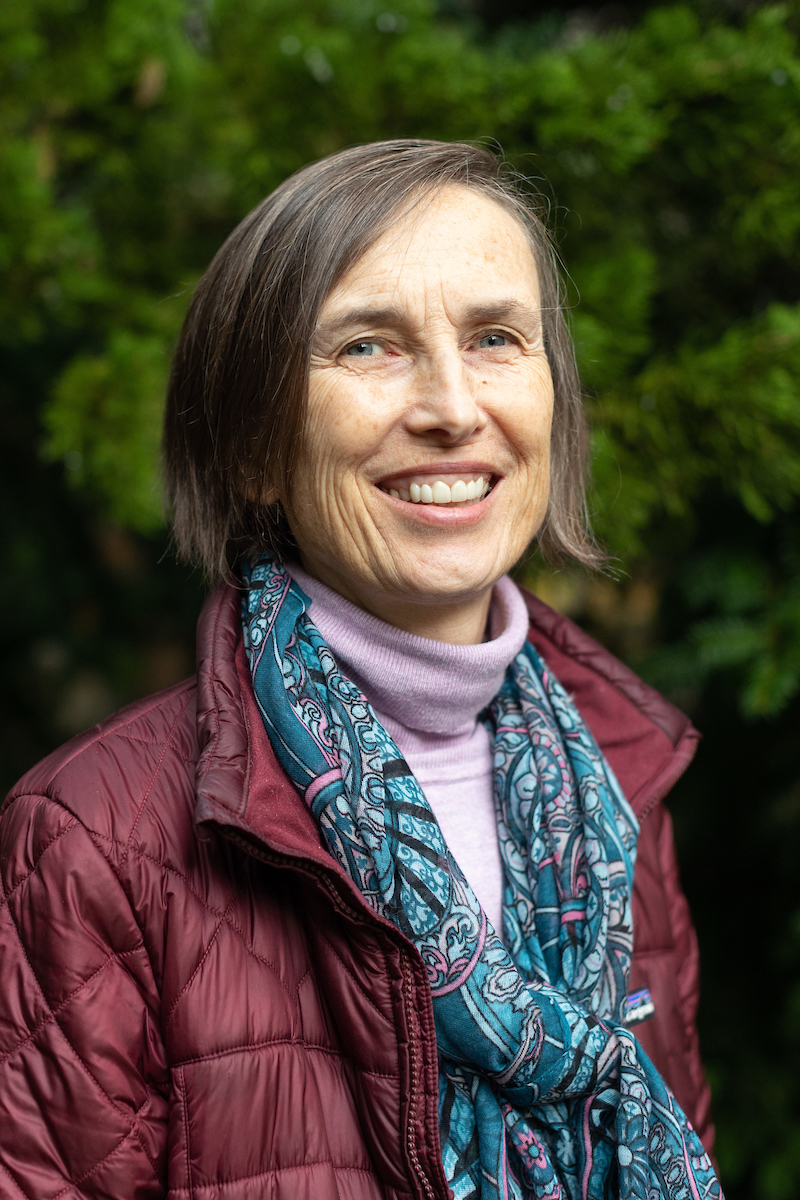 Rosemary smiling with chin length hair, wearing a scarf