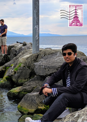 Man sitting on the rocks by the water