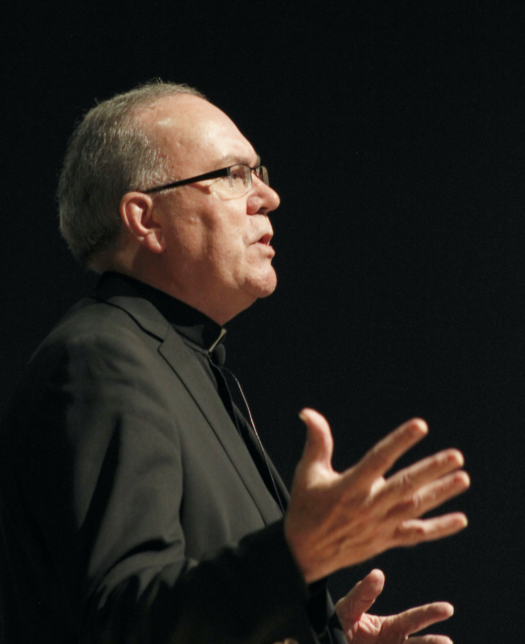 Father Steve against a black background