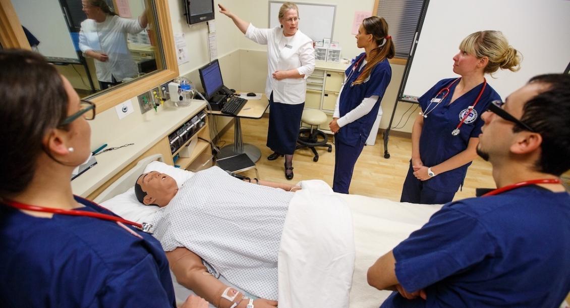 Teacher and students inside Clinical Performance Lab.