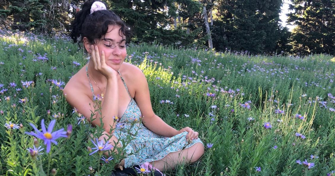 Student in a meadow of flowers