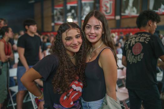 Two girls smiling at kickoff