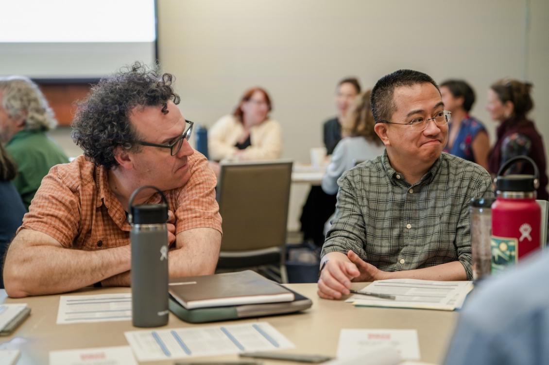 Professors at a table during one of the summit sessions