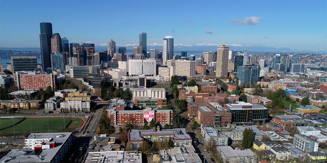 An aerial shot of the campus with the Seattle skyline in back.