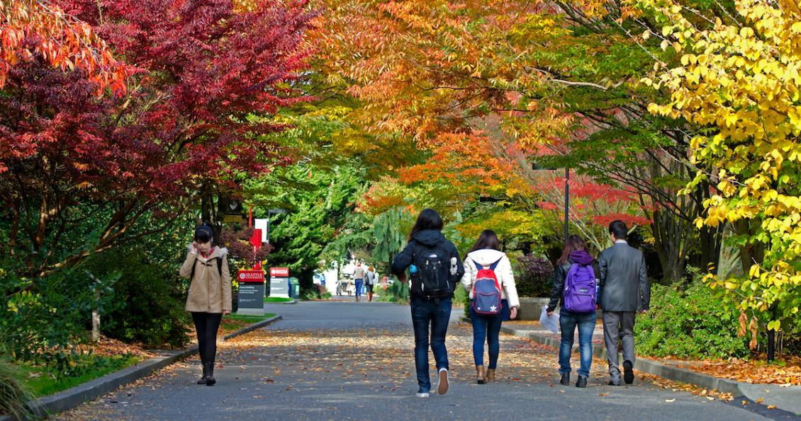 Students walking on campus in fall