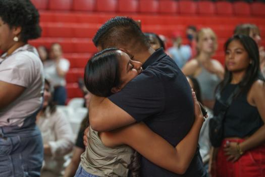 Dad hugging daughter at kickoff event