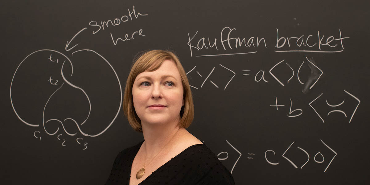 Portrait of Professor Henrich in front of chalkboard