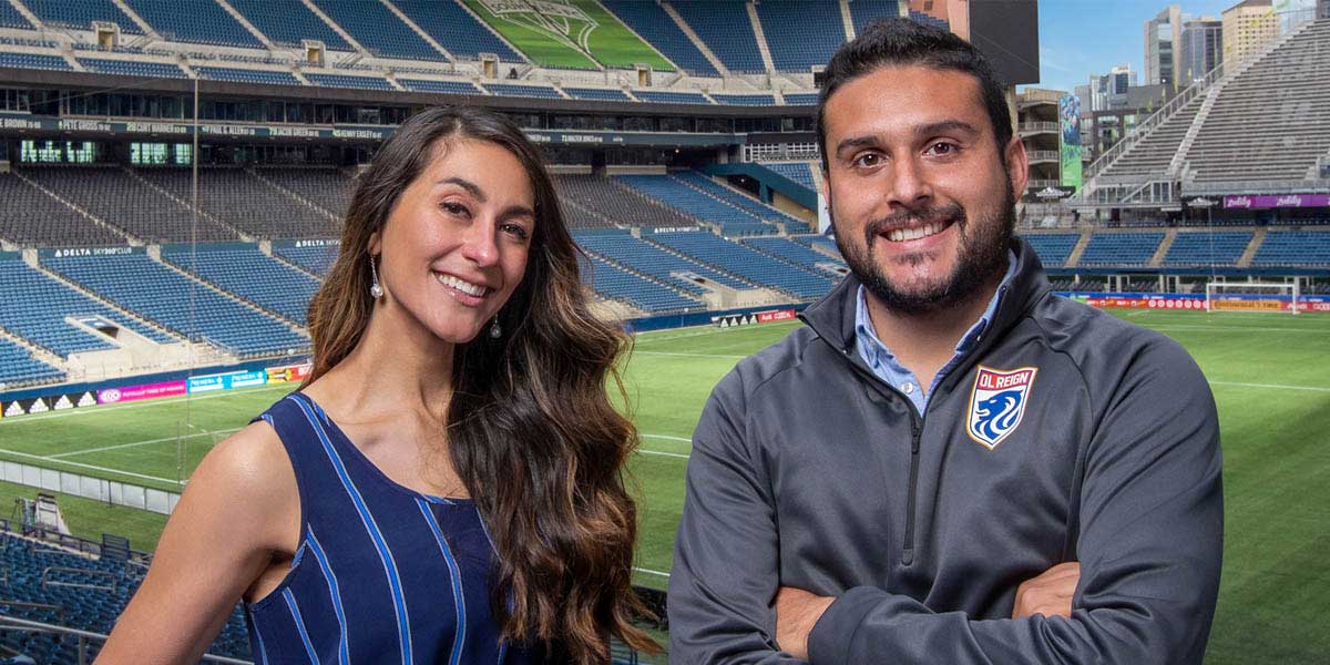 LainLaina Chavez, and  Santiago Gallo Villamizar standing in front of Lumen Field.