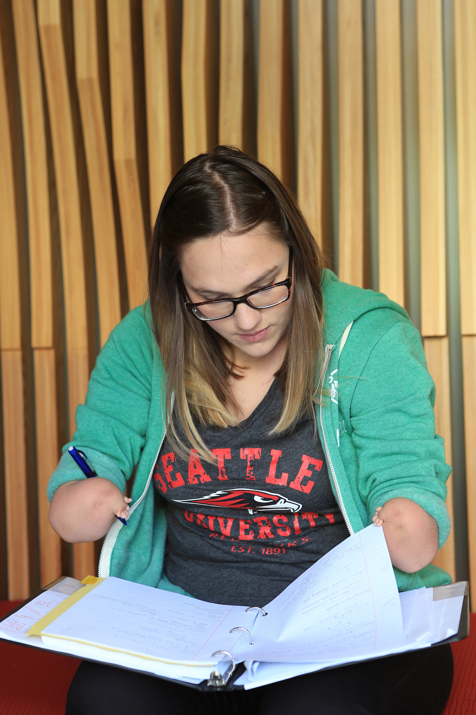 Student, Anna Picket, holding binder