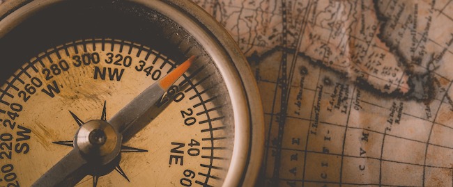 Photo of a compass on an antique map