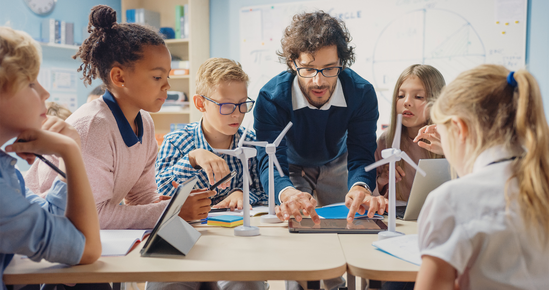 Teacher with students at a table