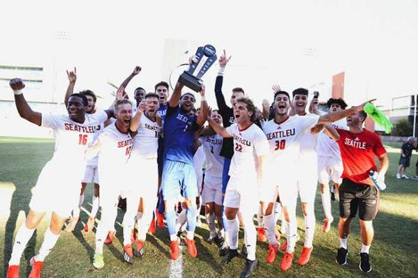 Soccer players holding a the WAC 2021 trophy