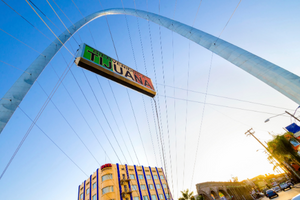 A metallic steel arch with a sign that says Welcome to Tijuana in Spanish