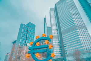 teal skyscraper with Euro logo statue