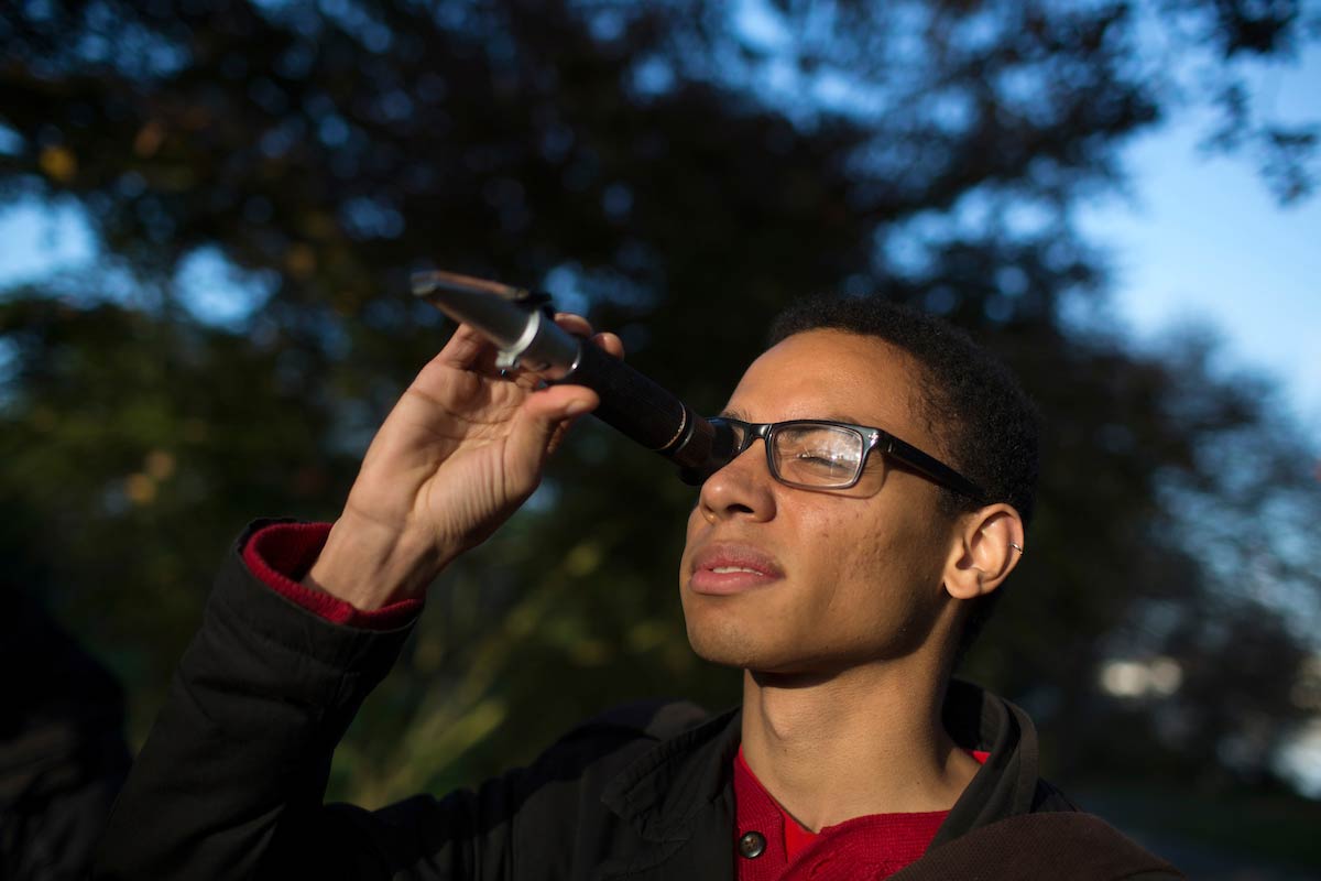 biology student looks through scope