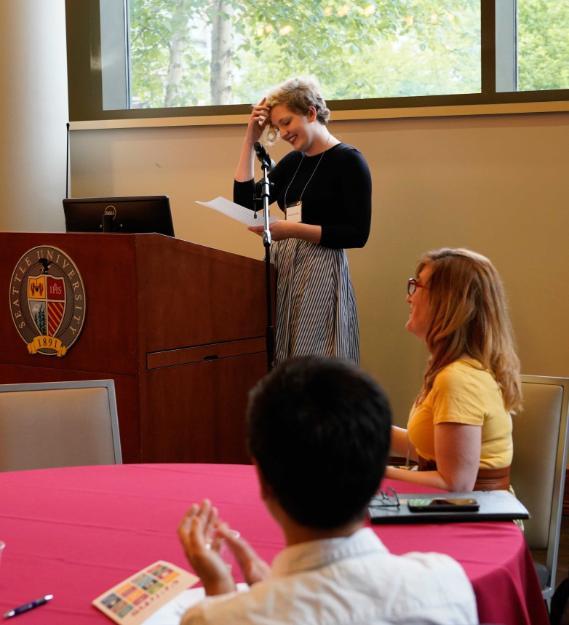 A student presenting behind a podium at SUURA