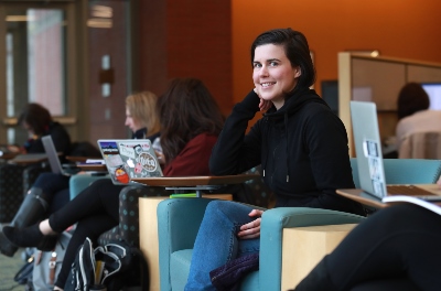 Image of undergrad female student studying in the library