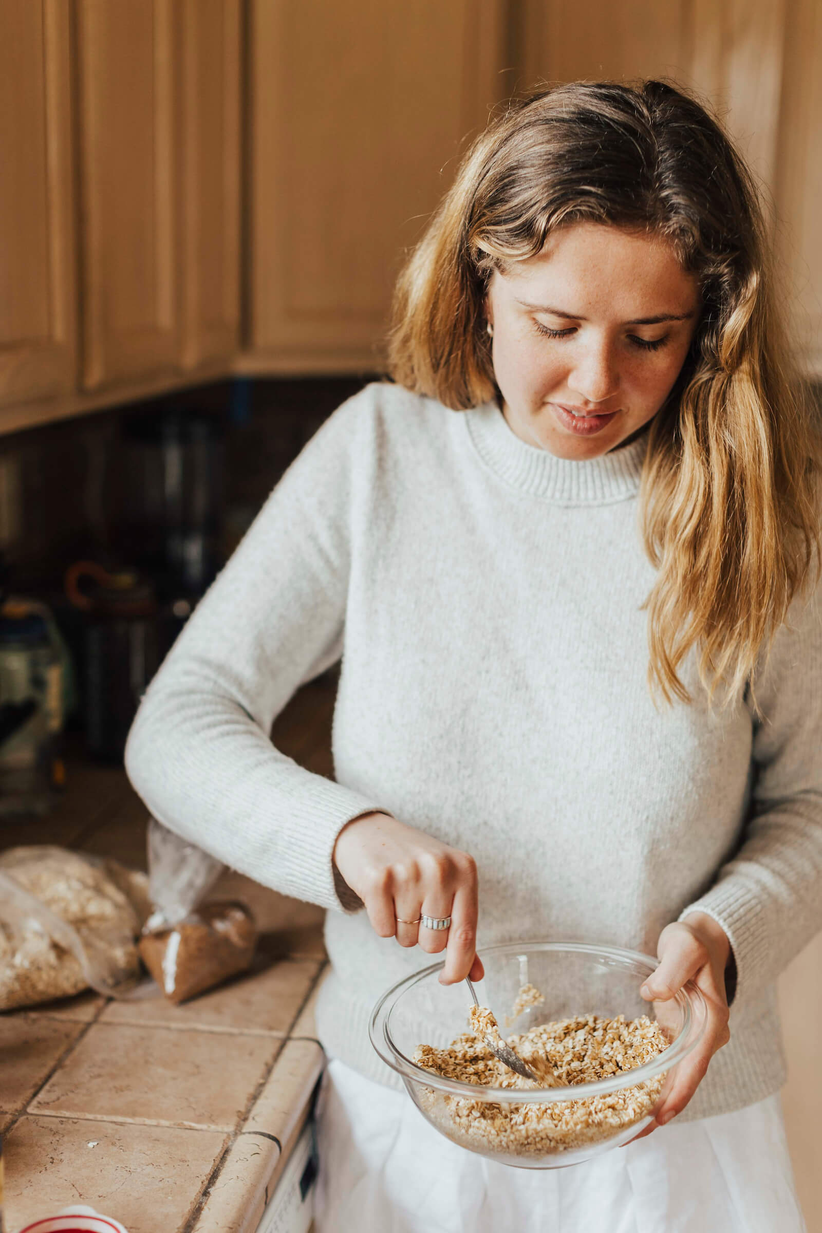 Hallie mixes ingredients in a bowl for cookies