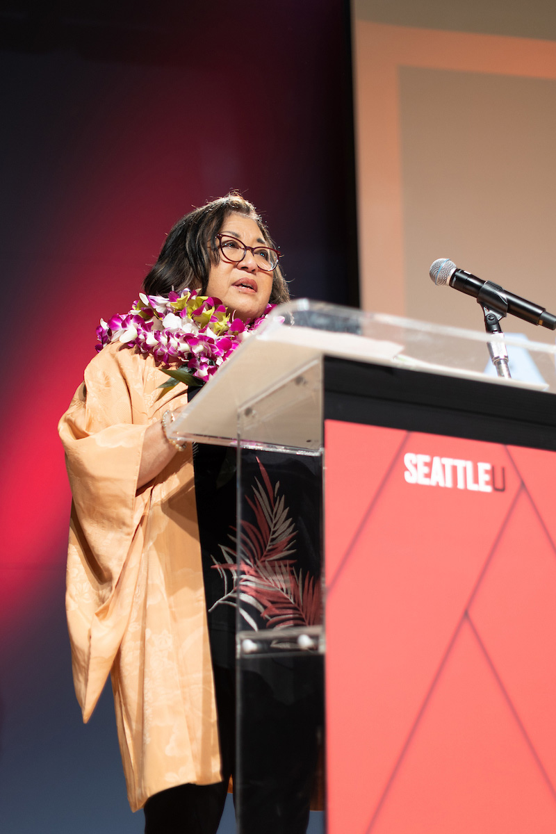 Mary Ann Goto at podium