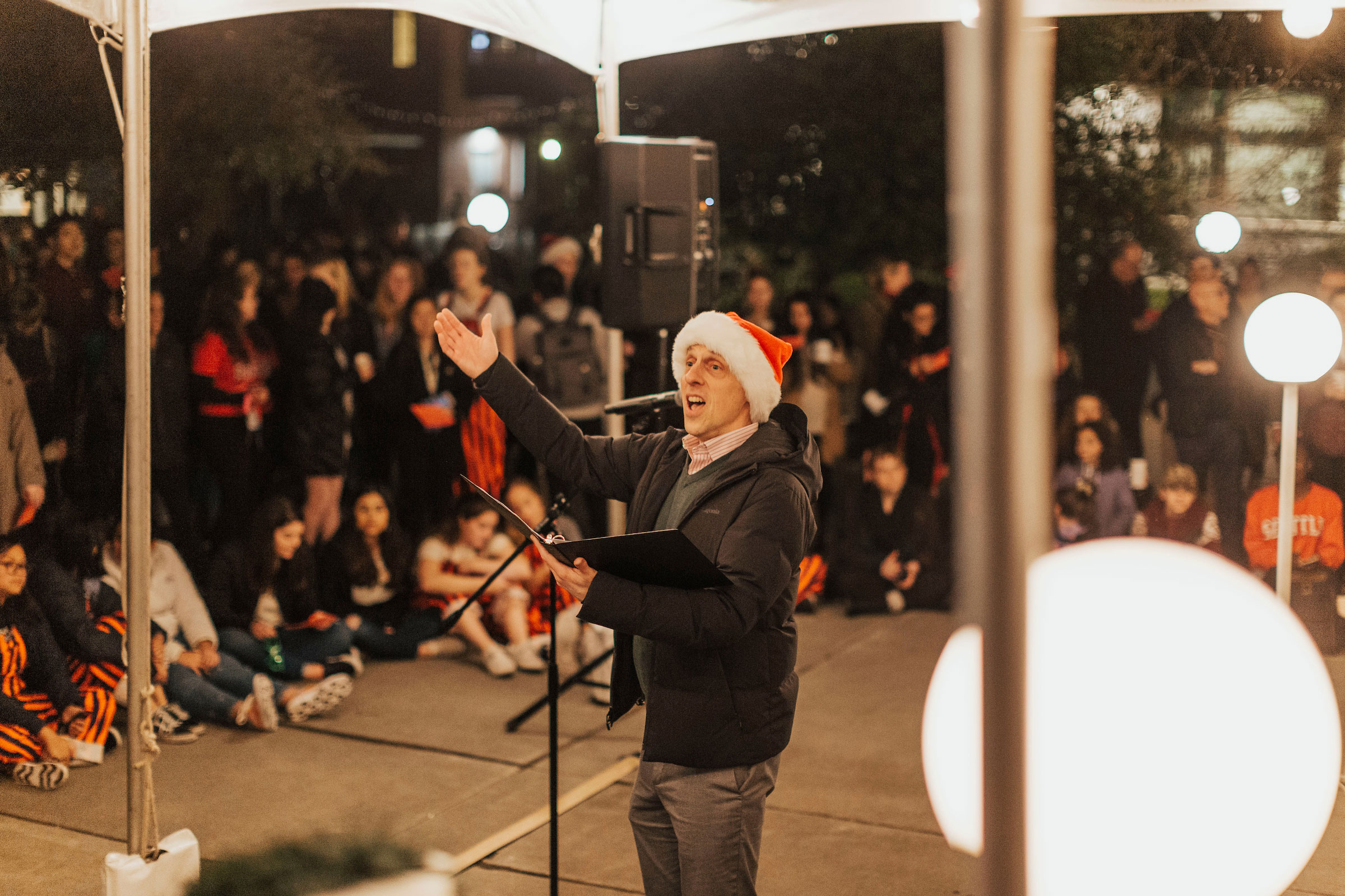 Choir Director leads the crowd in song 