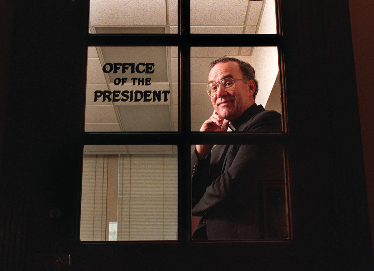 Father Stephen Sundborg stands inside his office door