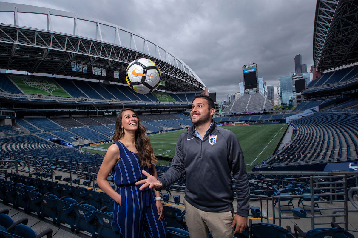 Two graduates of the Sports Leadership program pose at Lumen Field