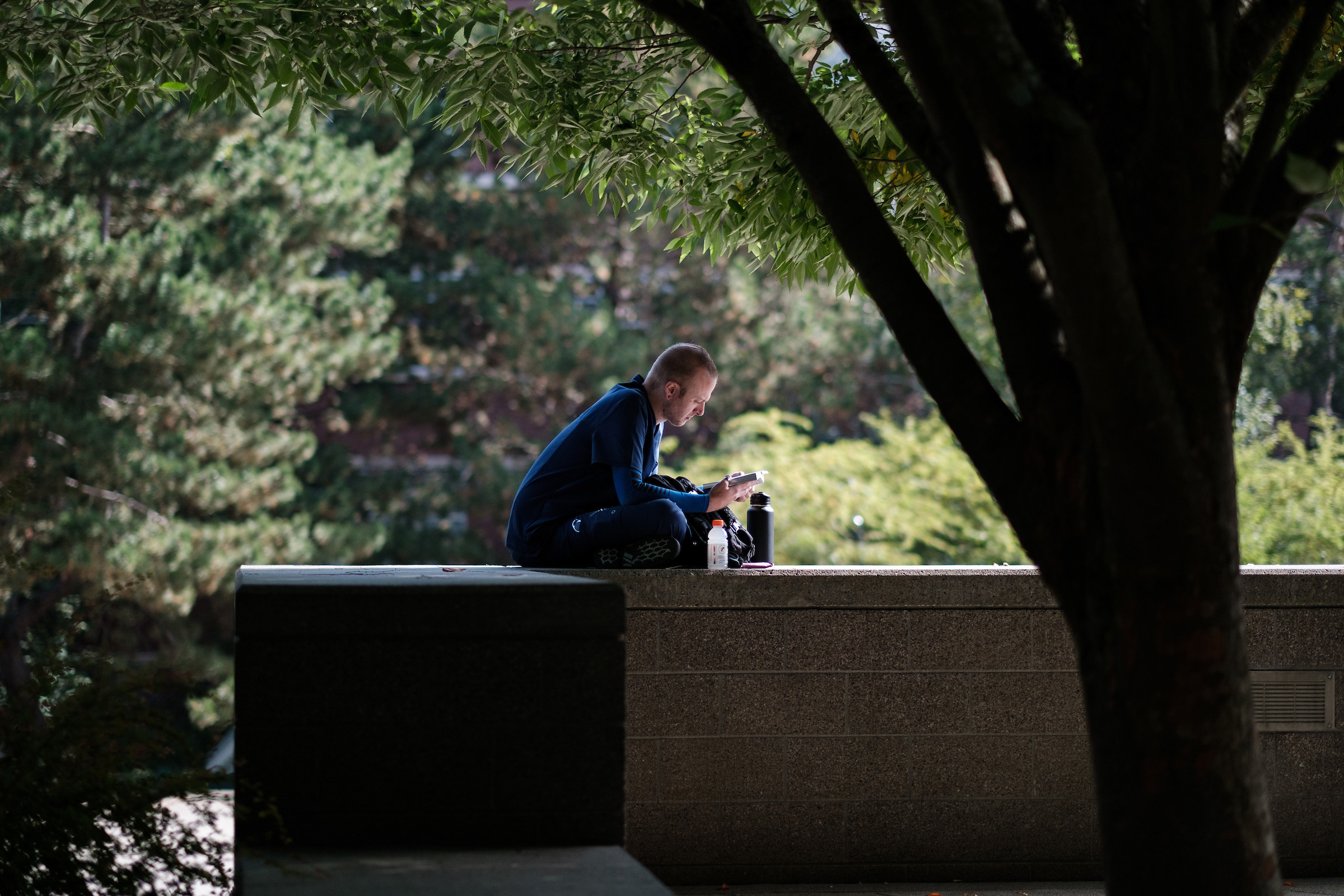 Student resting on ledge.