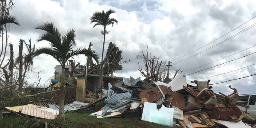 a pile of broken furniture in Puerto Rico caused by Hurricane Maria