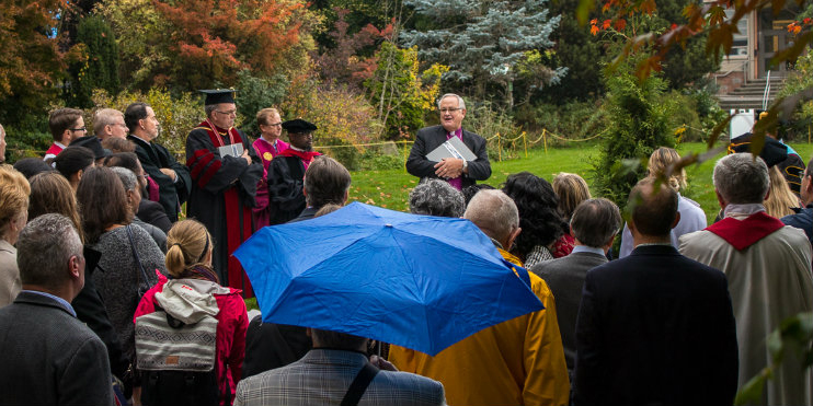 people gathered outside for a special service and tree planting