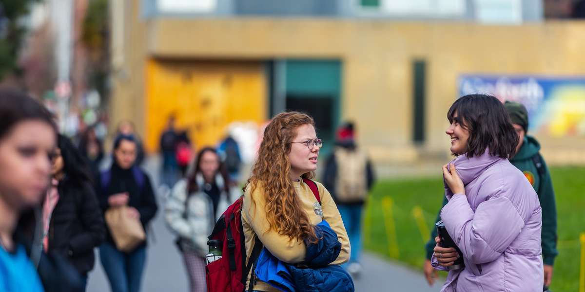 Students chatting and walking to class