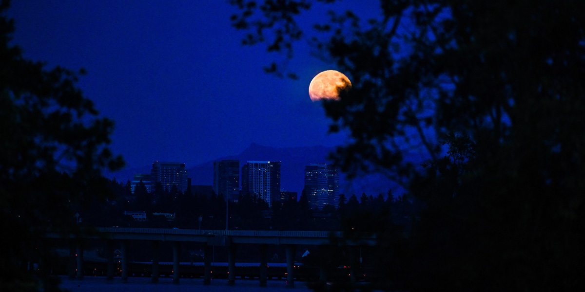 Seattle skyline and moon at night