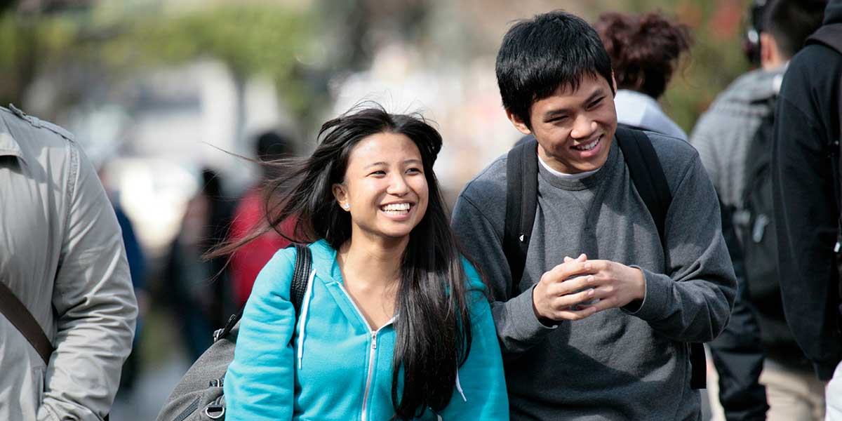 Two students walking on the upper mall