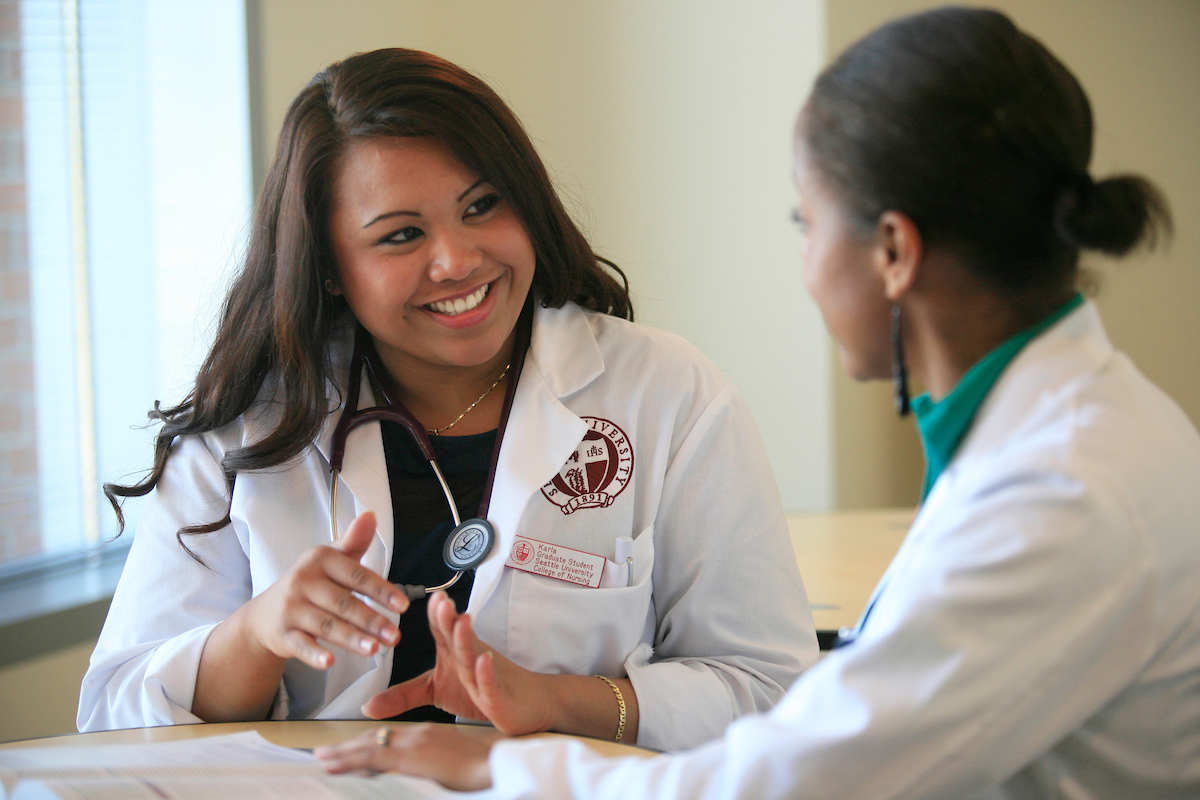 College of Nursing student in training with a patient.