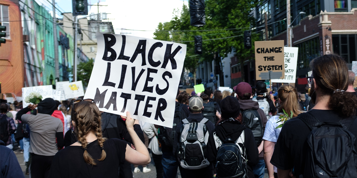 A group holding signs marches during protest