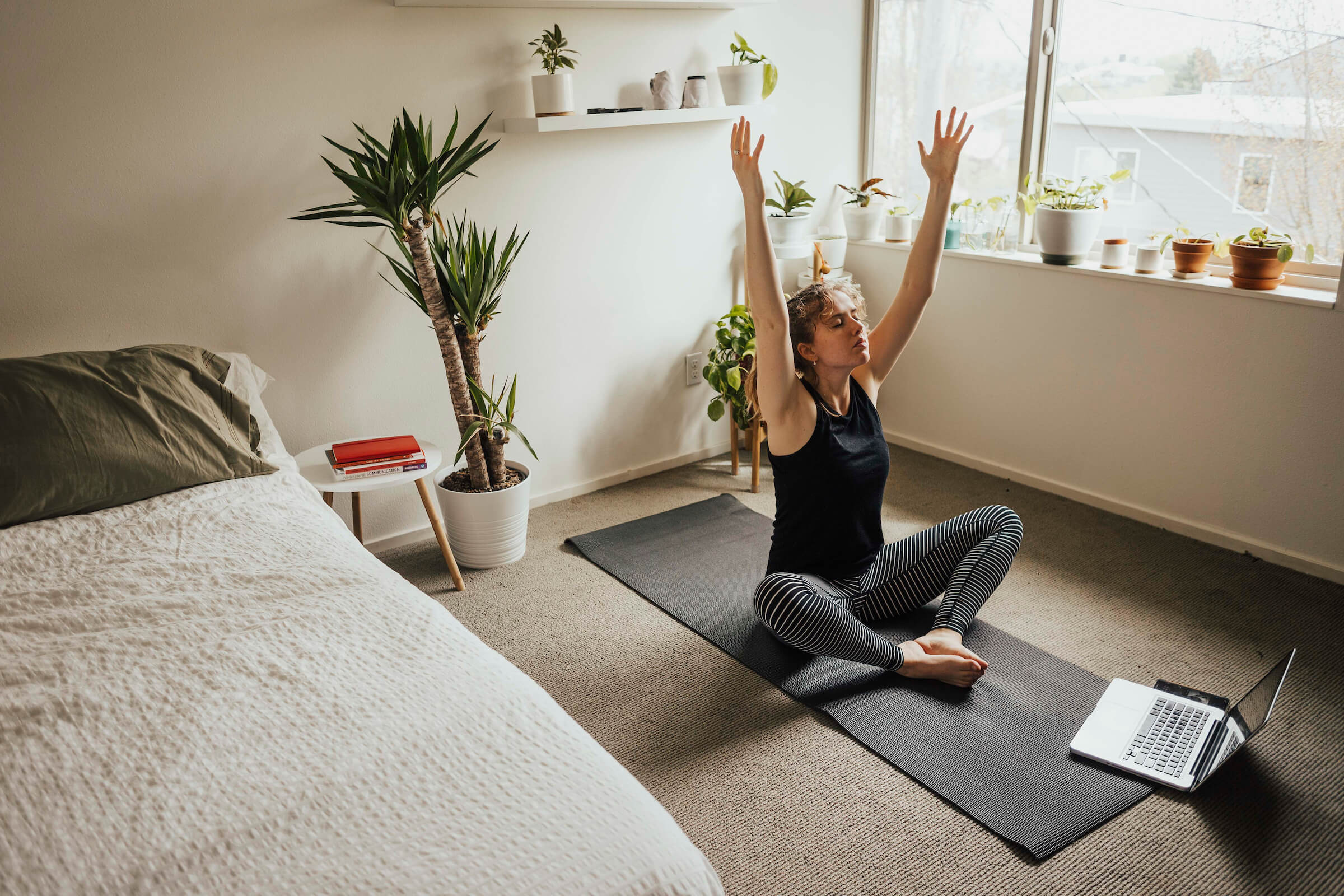 Hallie works on a pose while partaking in an online yoga class