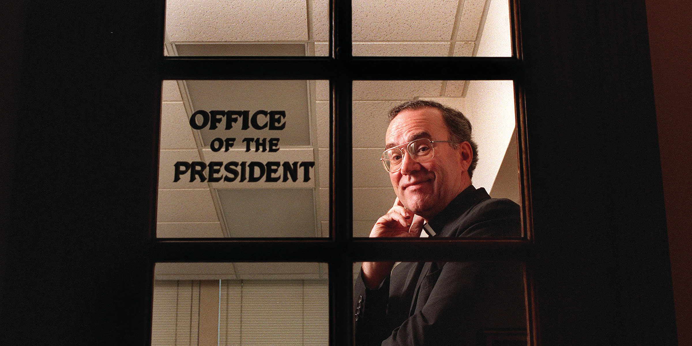 Father Stephen Sundborg stands inside his office door