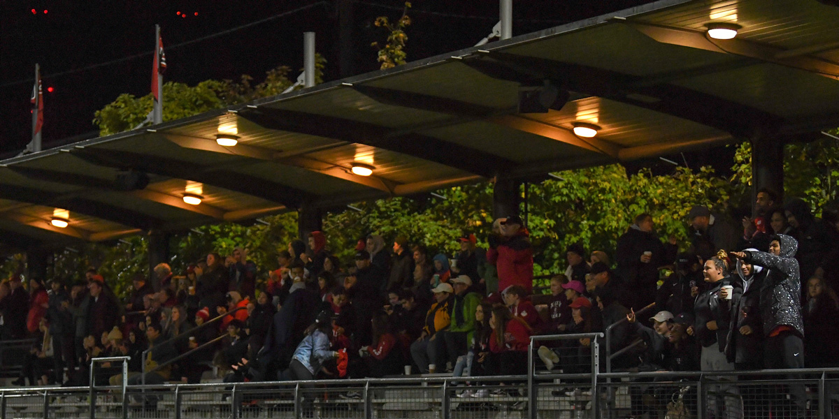 Lights above the crowd watching SU Men's Soccer play at night