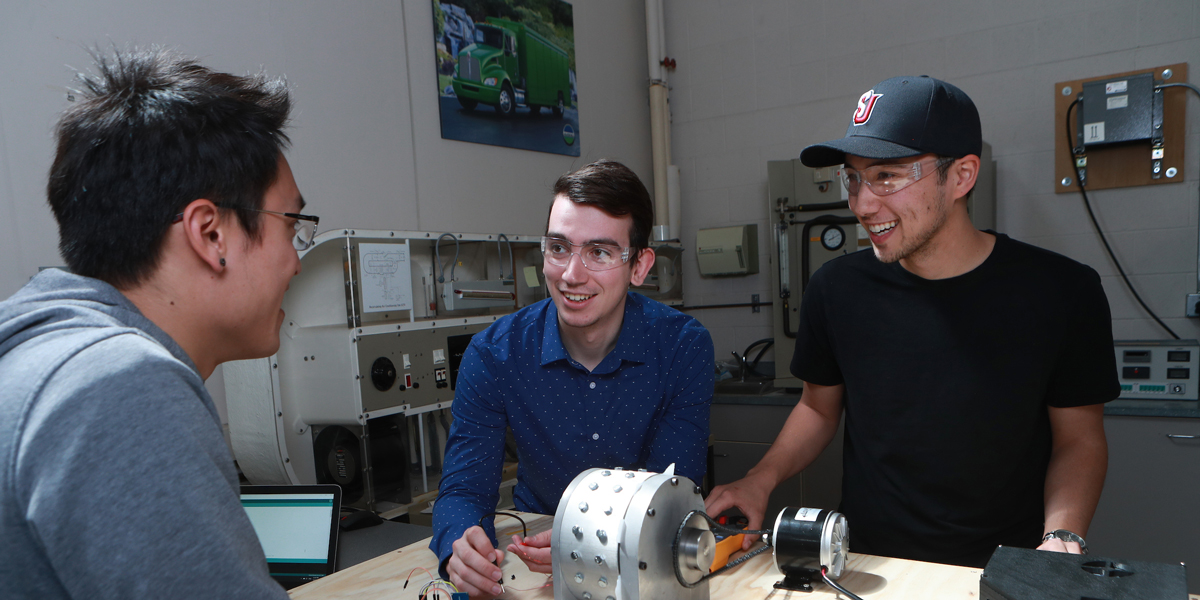 3 engineering students working on a project together