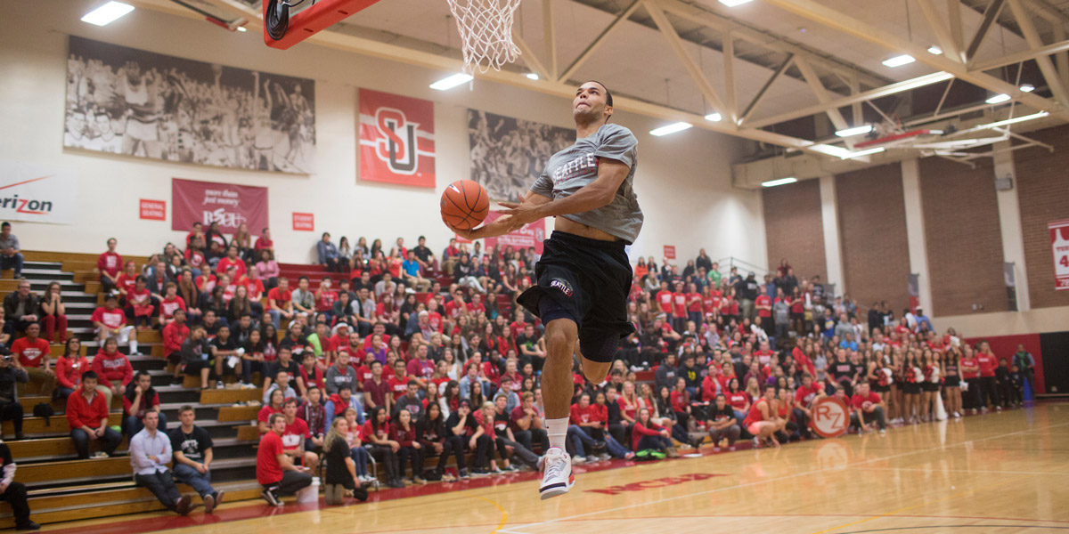 a SU Men's Basketball player mid-air at Connolly's North Court