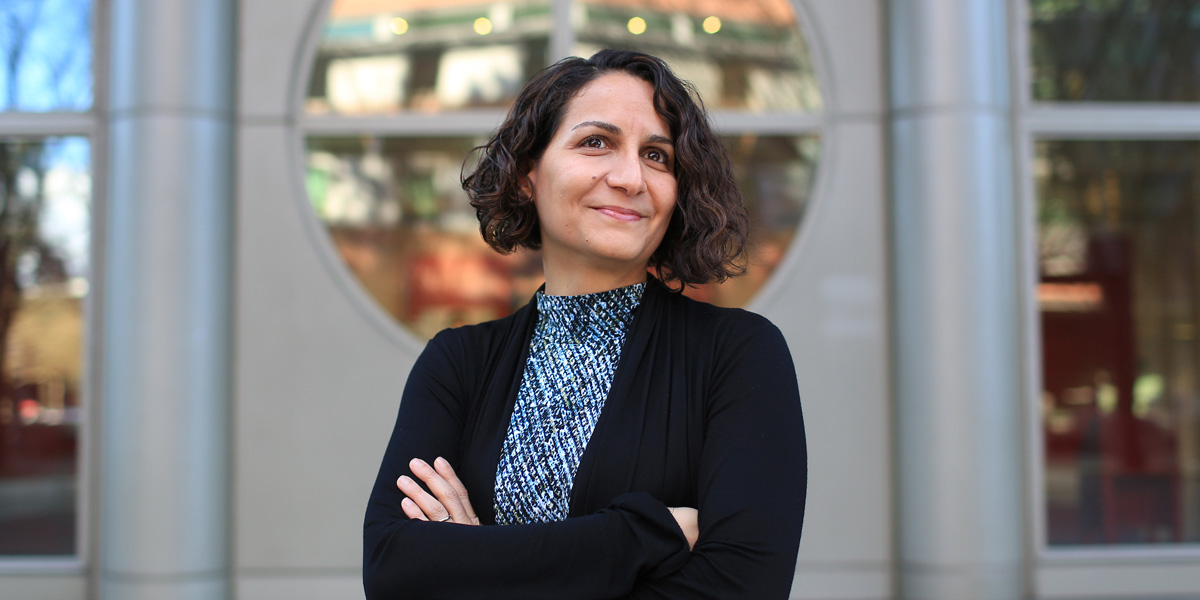 Roshanak Roshandel standing in front of the Engineering Building