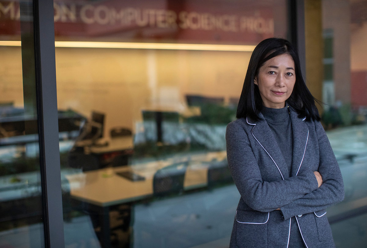 Professor Wan Bae stands outside the new Sinegal Center on campus.